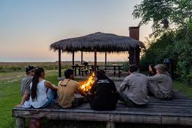 Grupo junto al fogón al atardecer en el Camping Carambolita