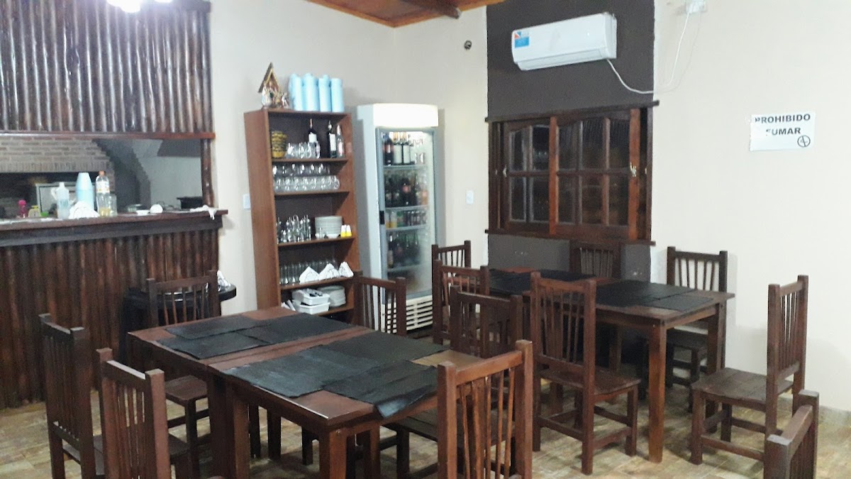 Interior de Karuhá con mesas de madera oscura y barra de servicio al fondo