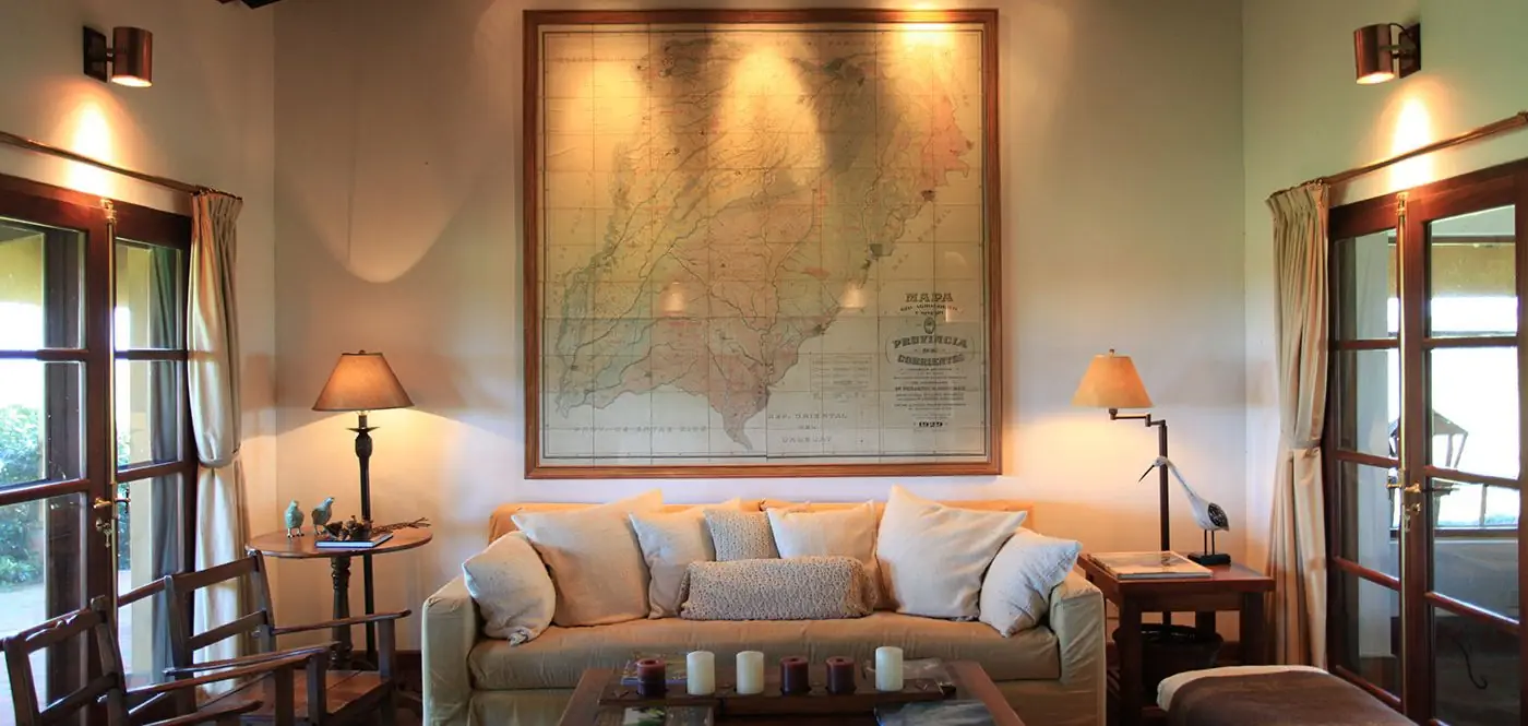 Salón principal con mapa histórico de Corrientes y sofás