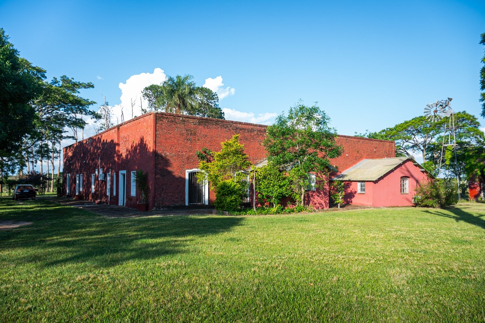 The brick main house surrounded by lawns
