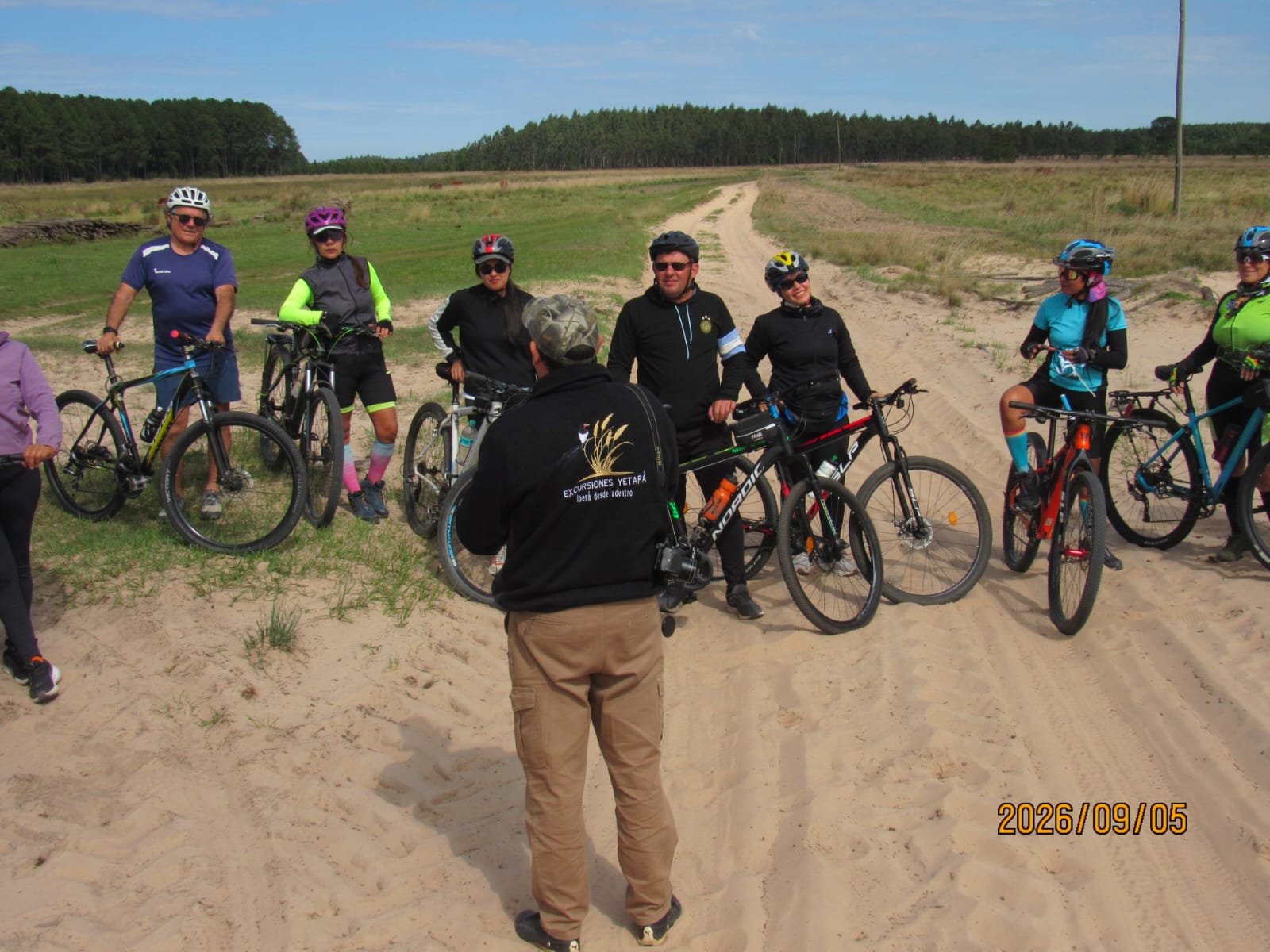 The group, who brought their own bikes, on the sand track with the guide