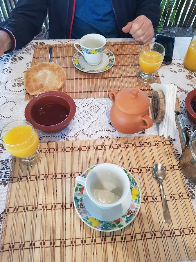 Desayuno campero: torta frita, jugo de naranja y tetera de barro