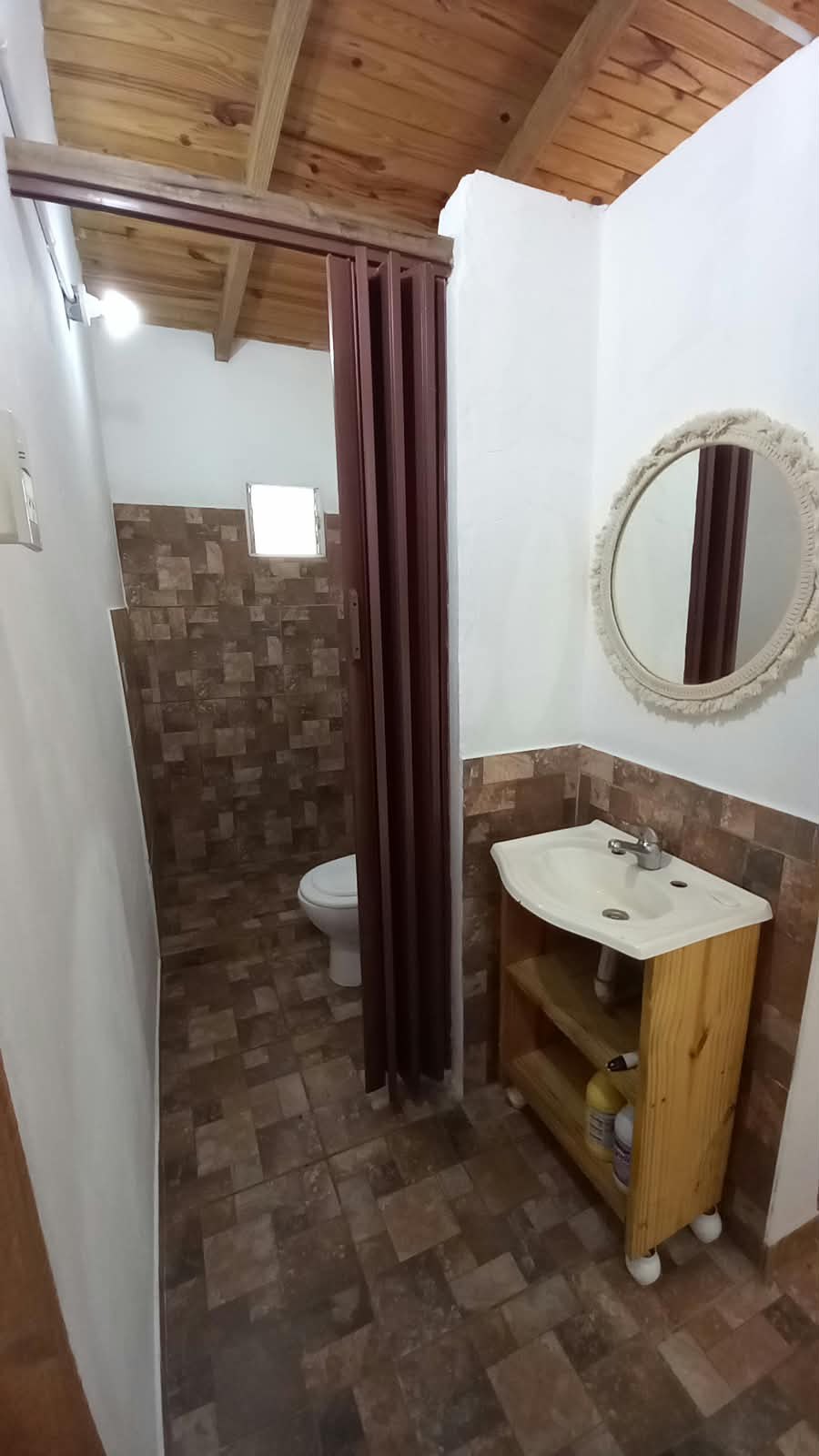 The bathroom, with a washbasin and a mirror
