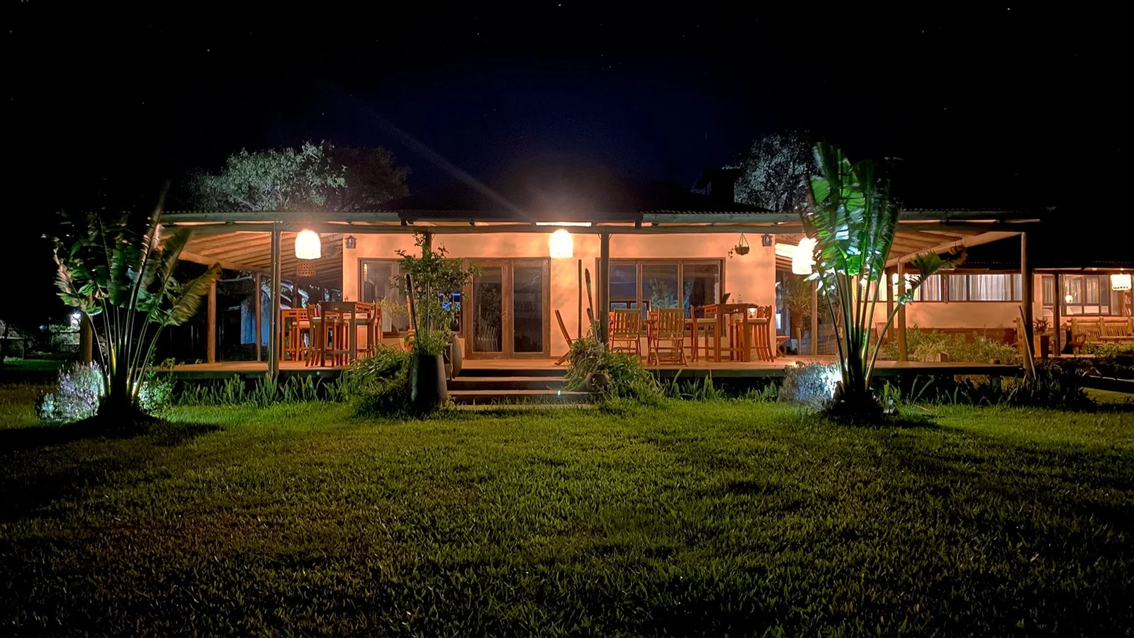 Fachada del Irupé Lodge iluminada con galería de madera