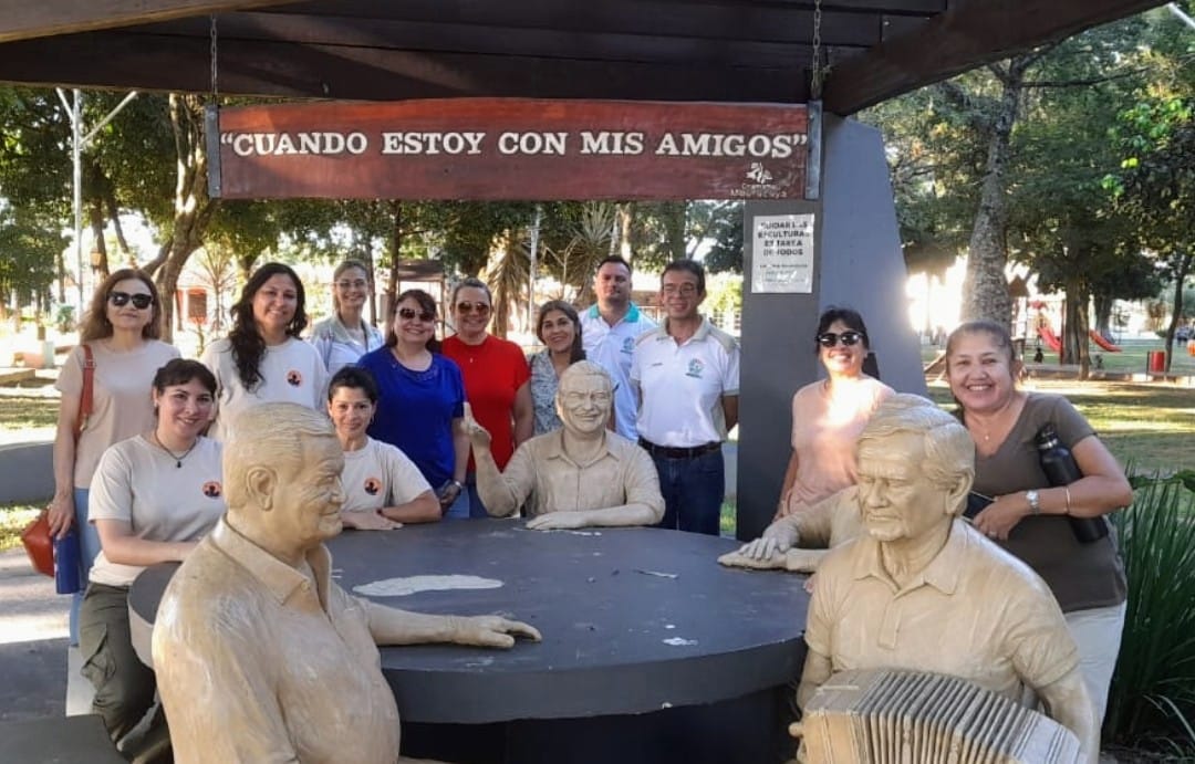 A group on the chamamé circuit, next to the sculptures of chamamé musicians in town