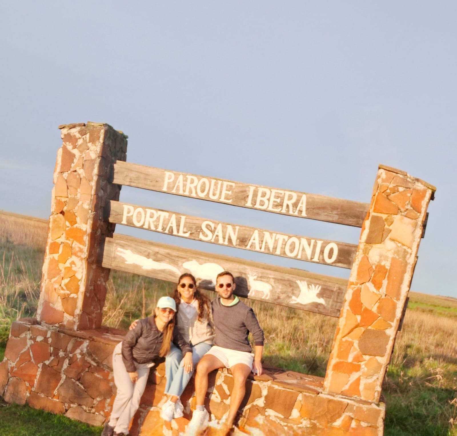 Visitors at the entrance sign of the San Antonio portal