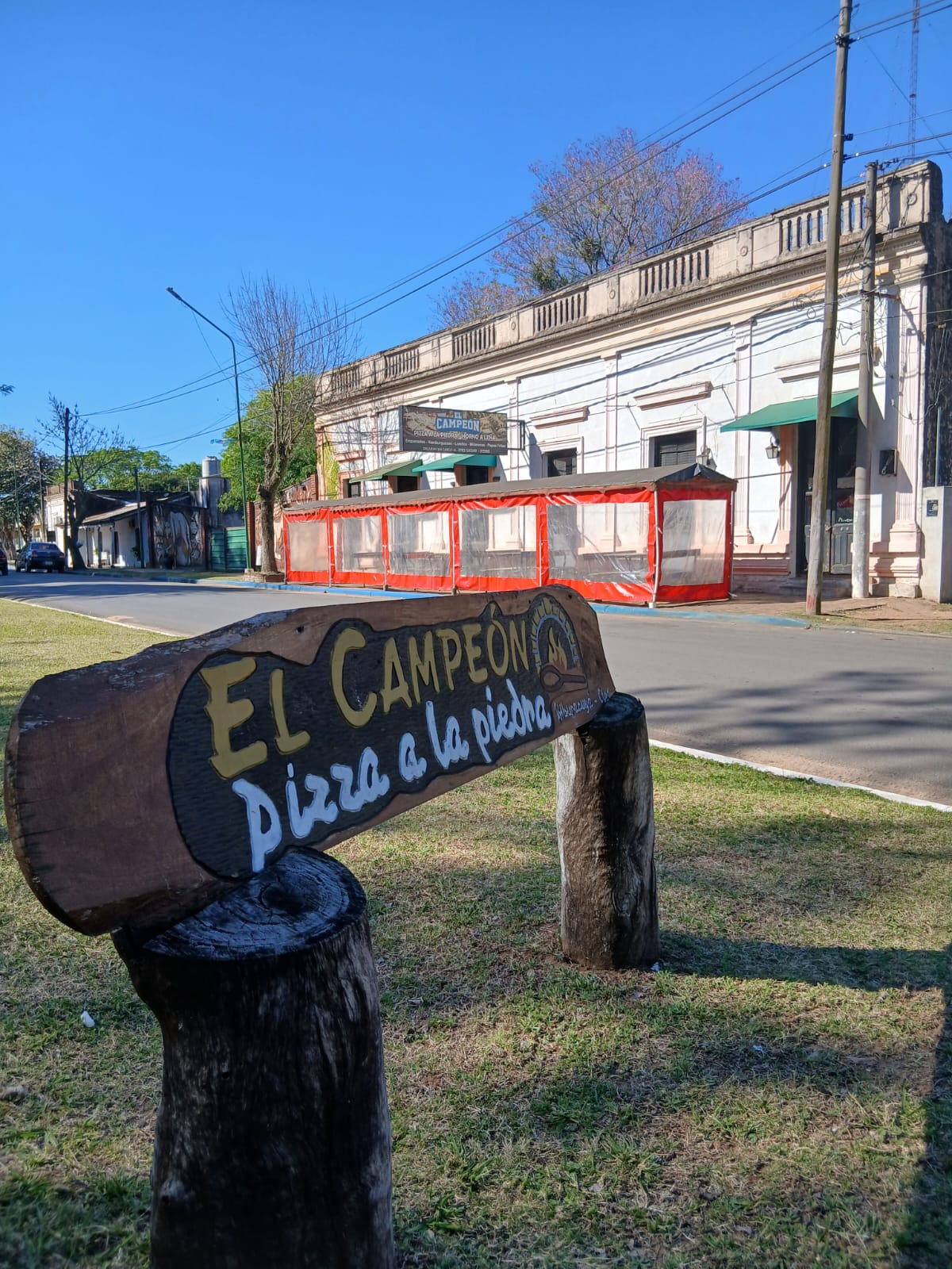 El Campeón's wooden sign, with the shop behind
