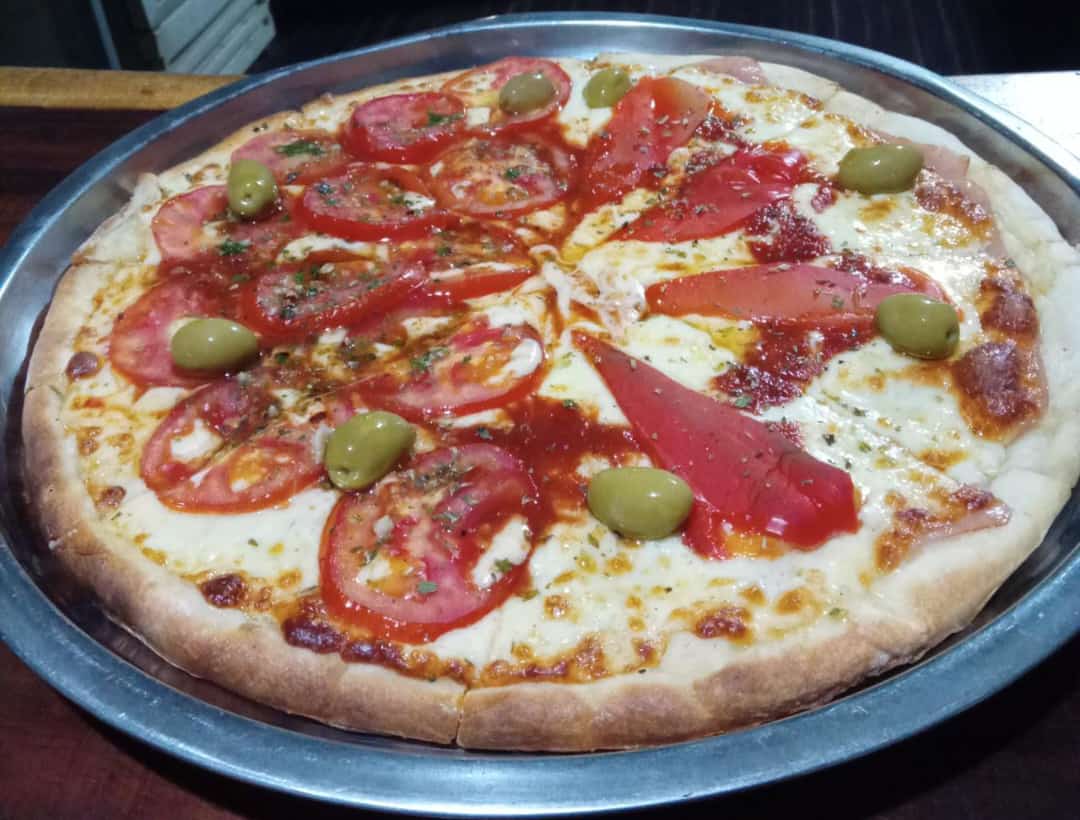 Pizza with tomato, red pepper and olives
