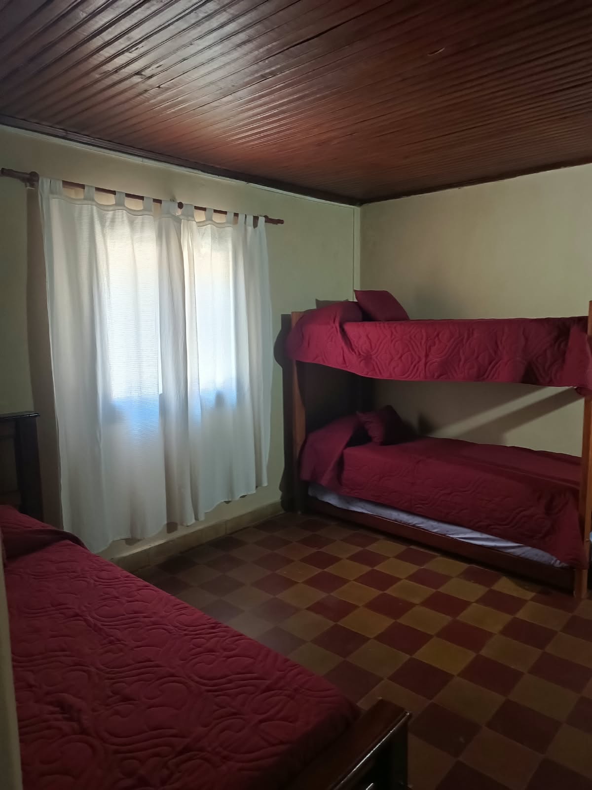Room with a bunk bed and a single bed
