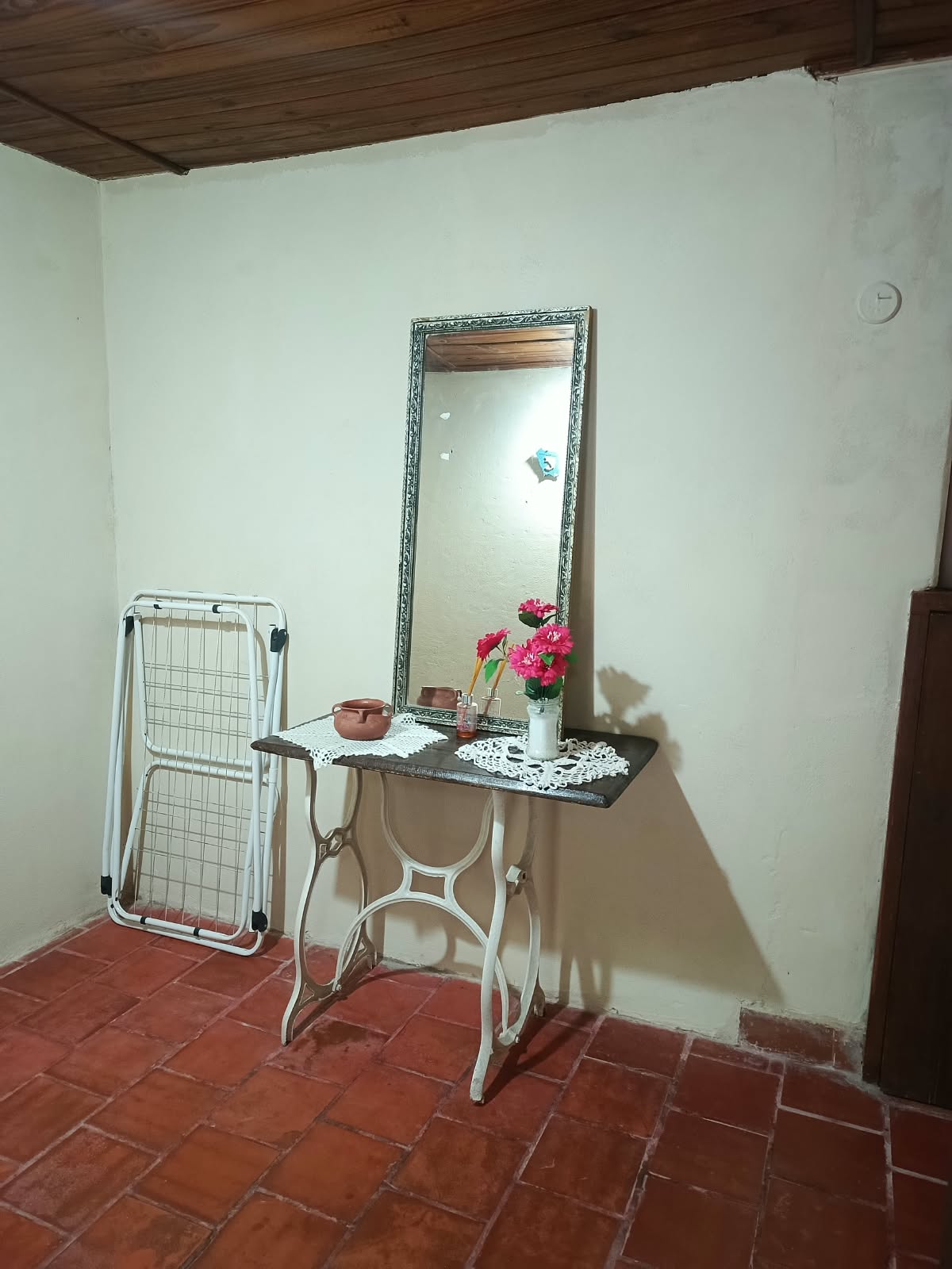 A corner of the room, with a mirror