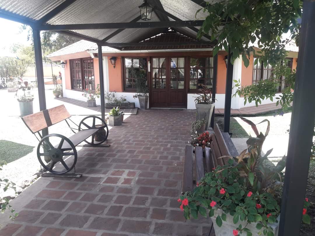 The covered entrance gallery, with benches and planters
