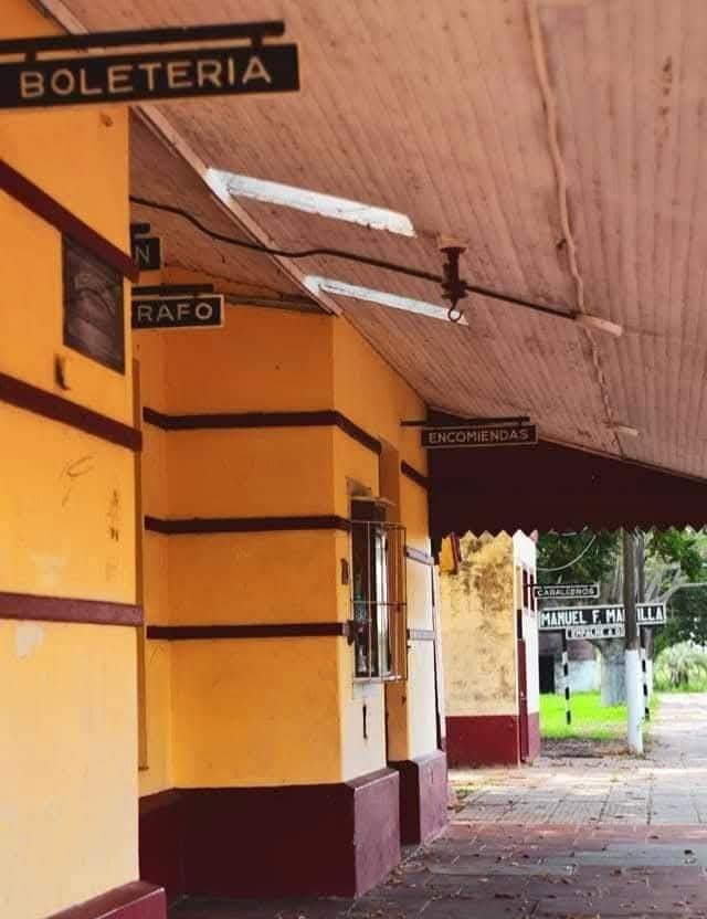 The covered platform of the former station, with the ticket office and parcels signs